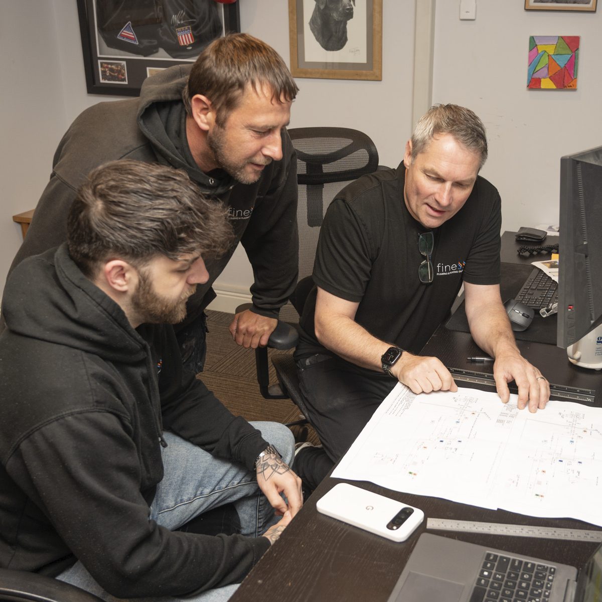 The Finesse team reviewing plans in the office